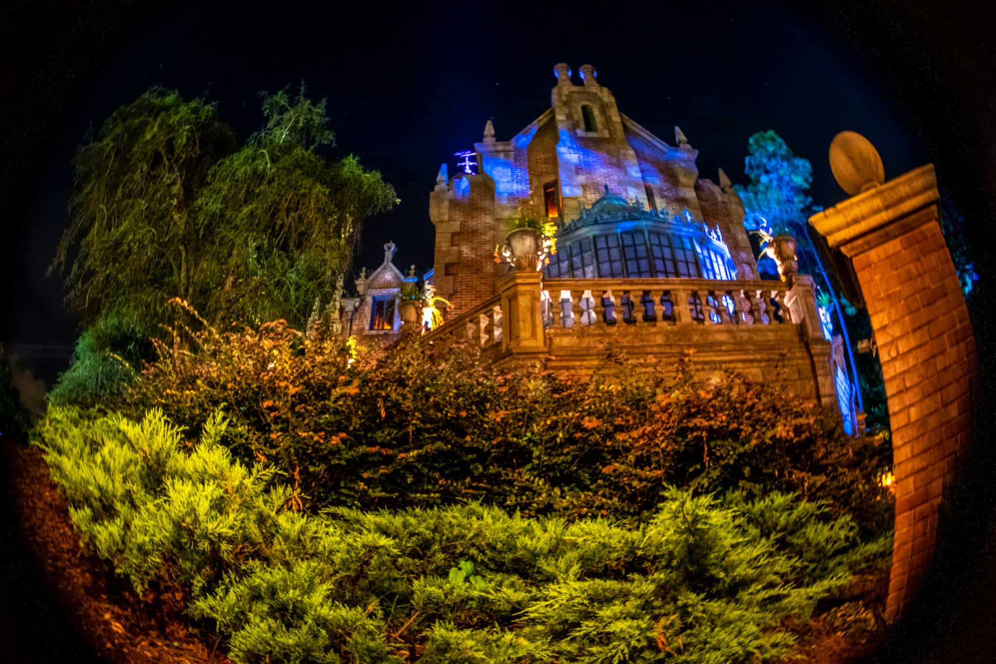 The Haunted Mansion exterior lit at night