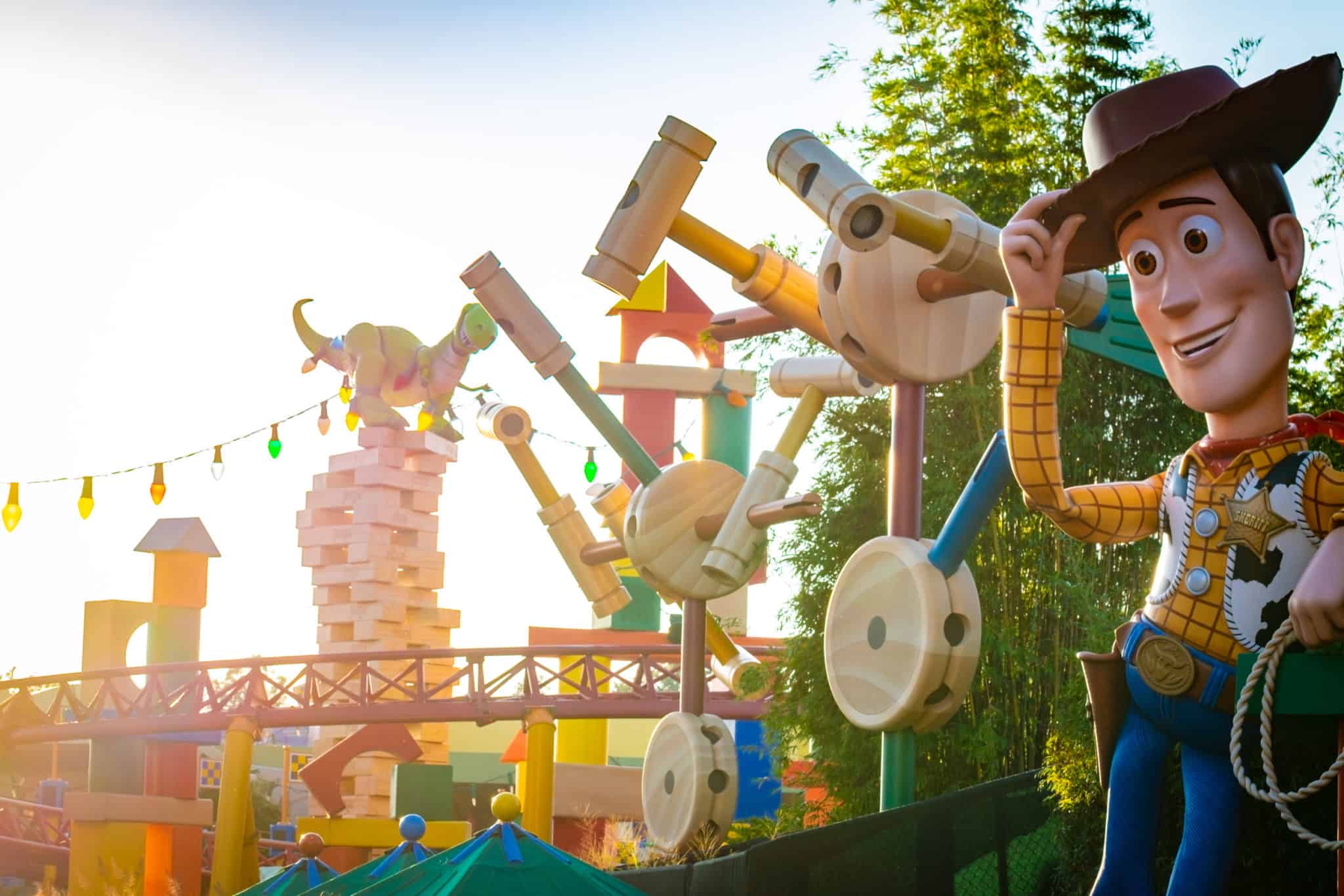 Toy Story Land at Hollywood Studios during a golden sunset with colorful toy-themed attractions visible