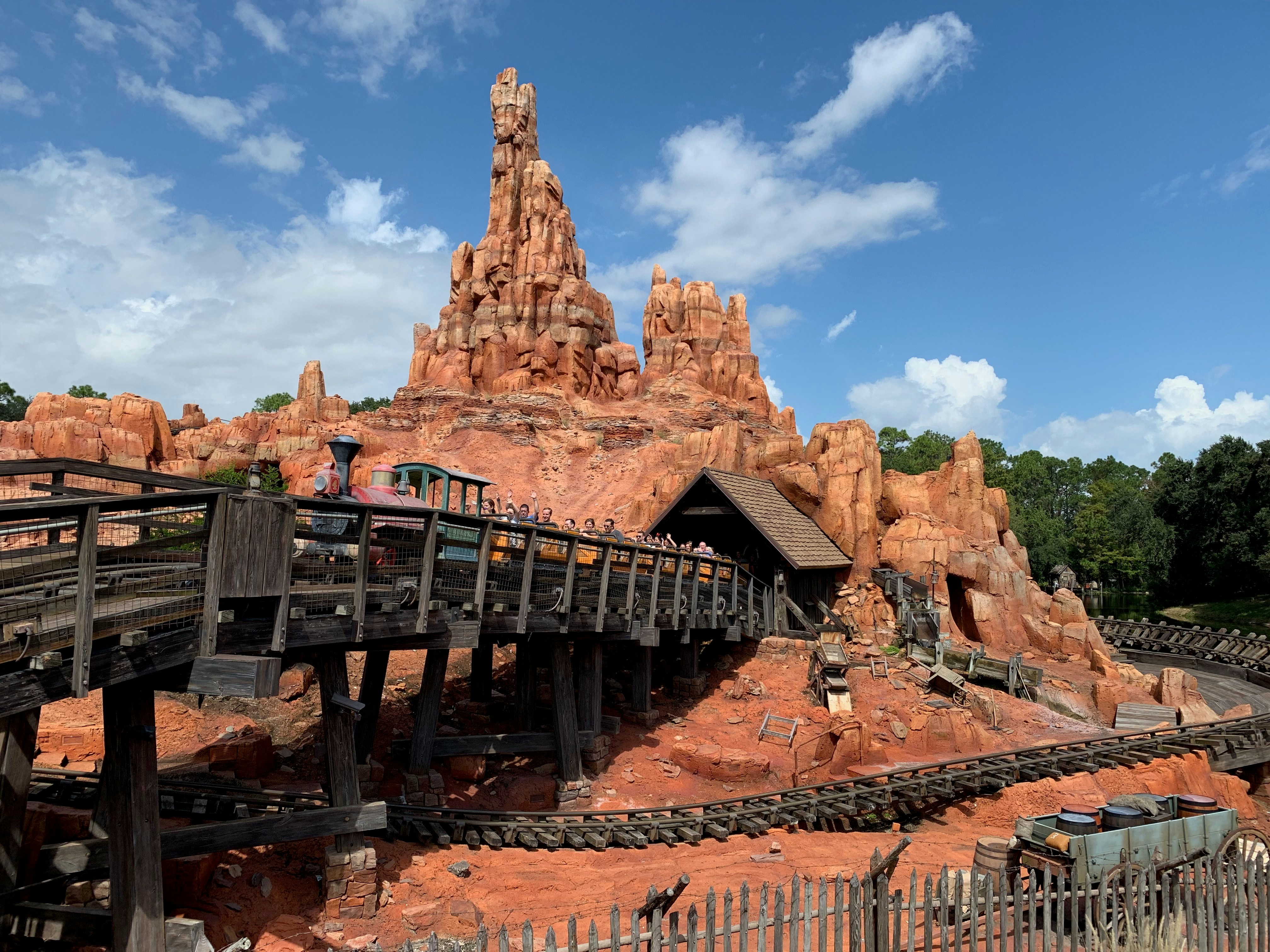 Big Thunder Mountain Railroad coaster train on the track with the mountain structure behind it