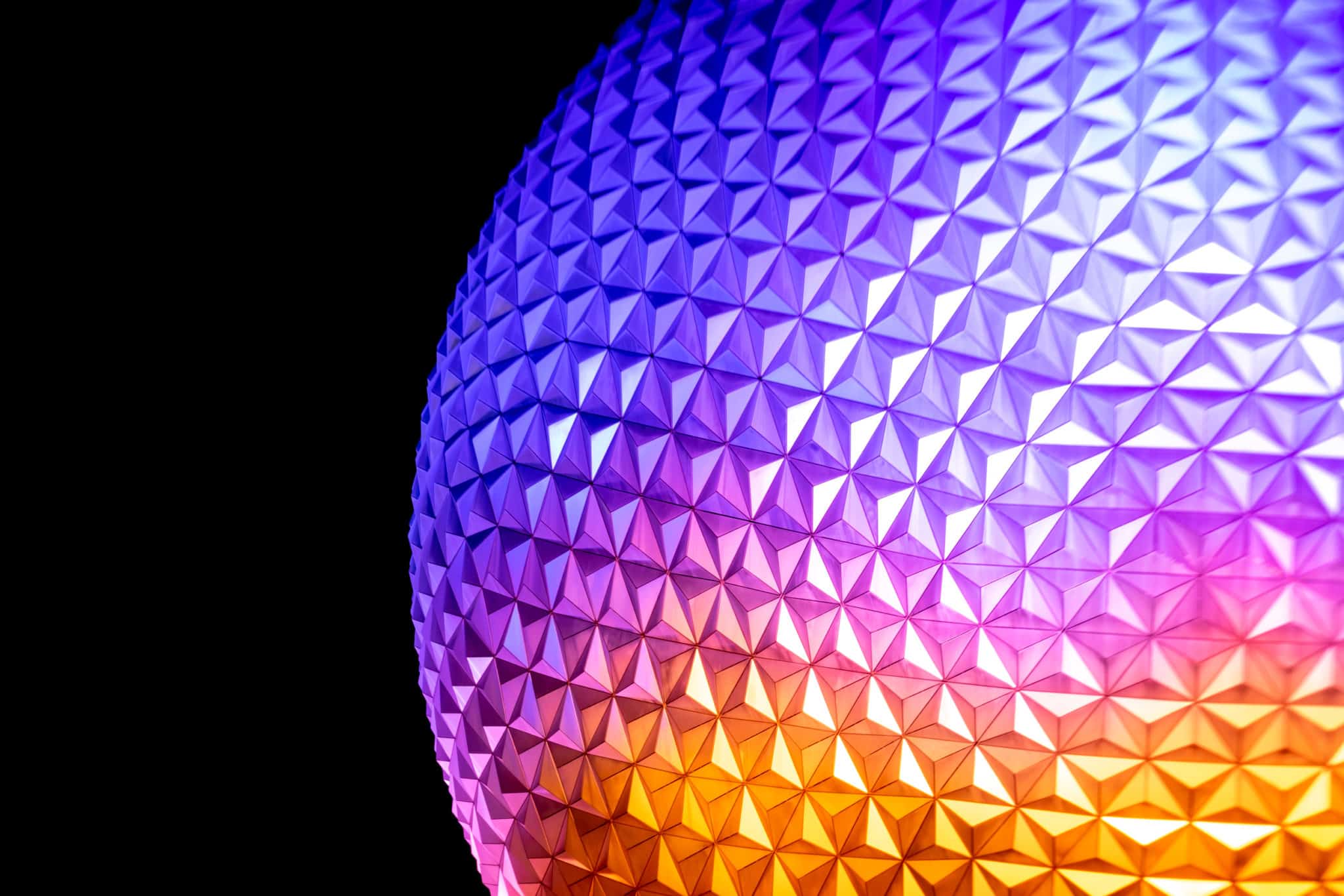 Spaceship Earth glowing at night during Festival of the Holidays