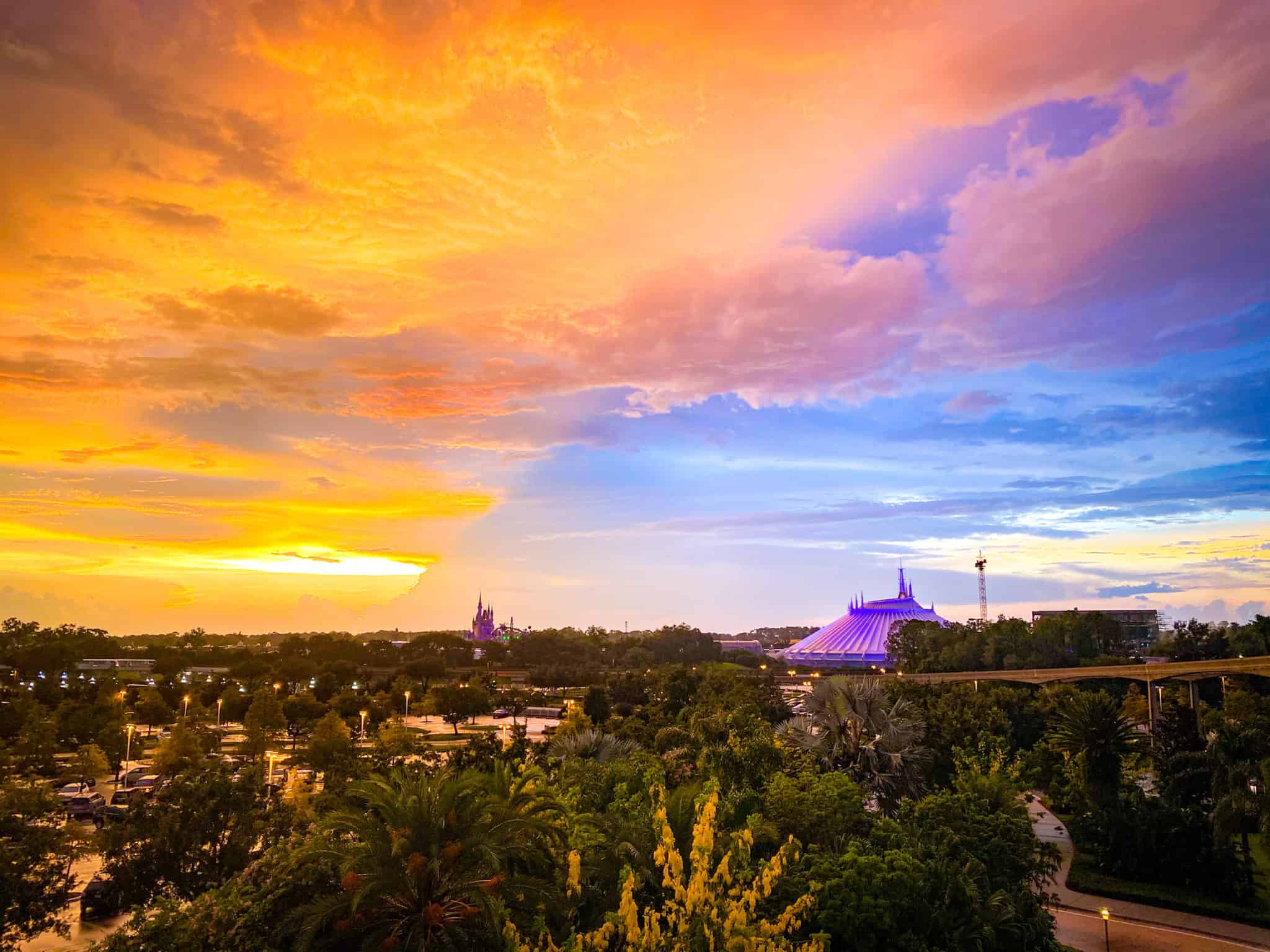 The Contemporary's A-frame tower at sunset, with Cinderella Castle on the horizon